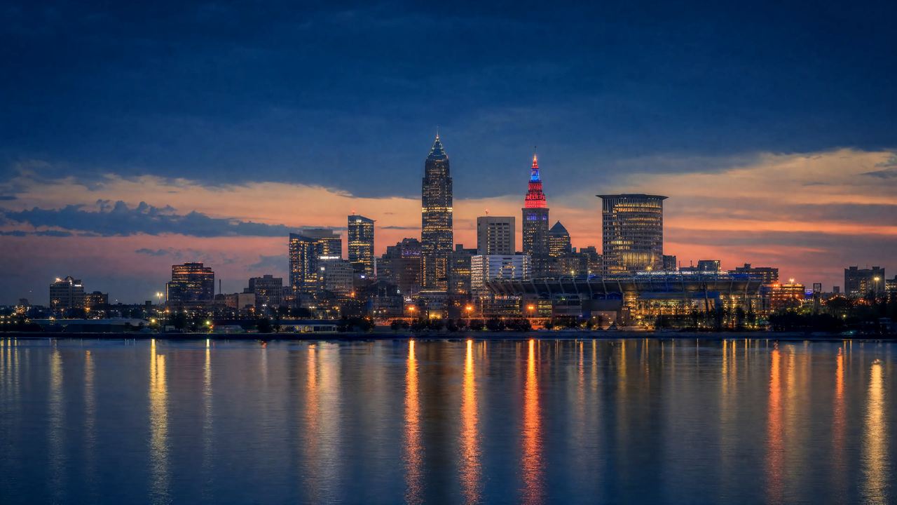 Cleveland skyline at dusk across Lake Erie